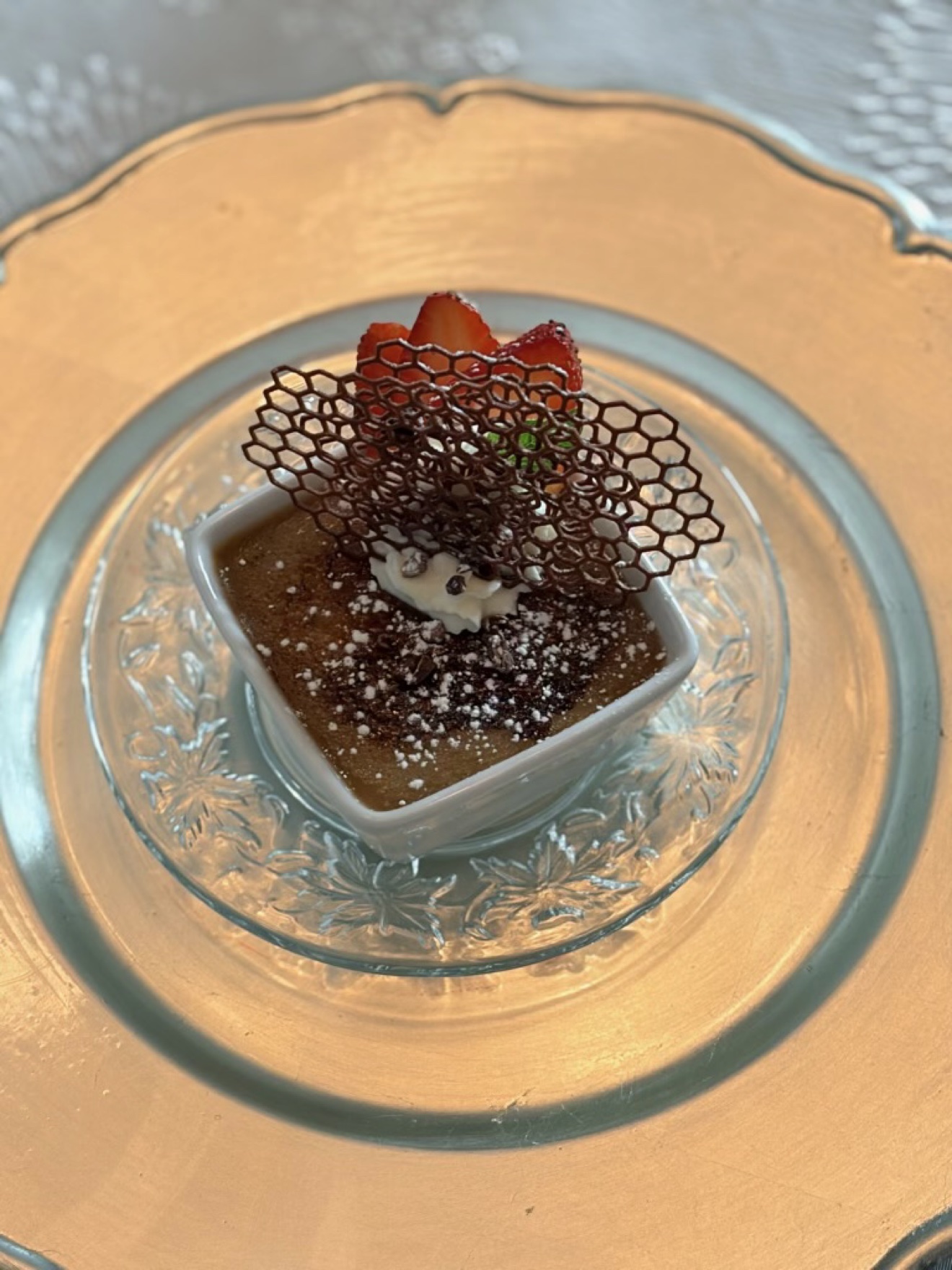 Chocolate pot de crème with chocolate tuile and strawberries