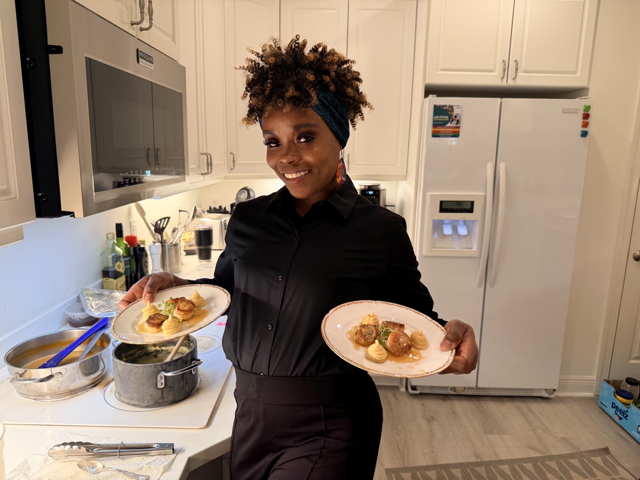 A member of Chef Tony's team presenting plated courses